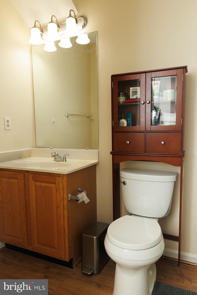 bathroom featuring hardwood / wood-style flooring, vanity, and toilet