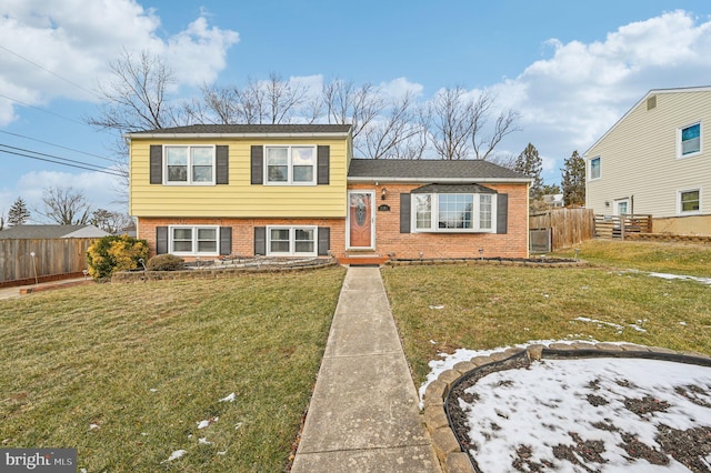 tri-level home with a front lawn