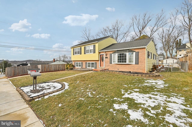 tri-level home with a front yard