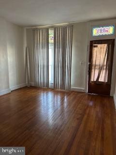 entryway featuring a healthy amount of sunlight and dark hardwood / wood-style flooring