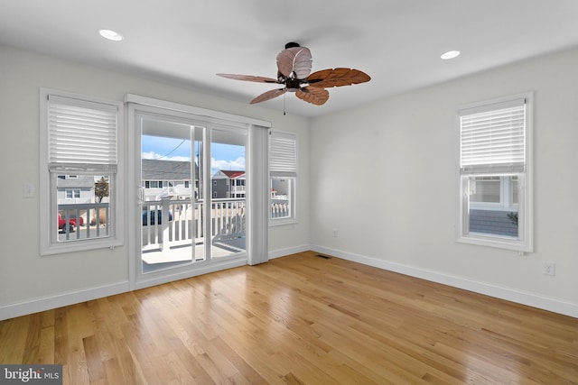 unfurnished room with light wood-style floors, ceiling fan, baseboards, and recessed lighting