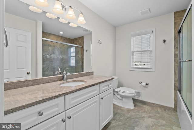 bathroom with vanity, a tile shower, and visible vents