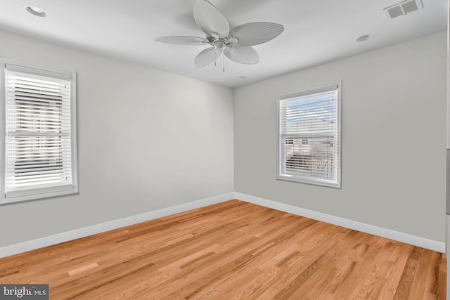 empty room featuring recessed lighting, a ceiling fan, light wood-style floors, visible vents, and baseboards