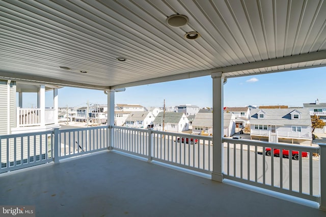 view of patio with a balcony and a residential view