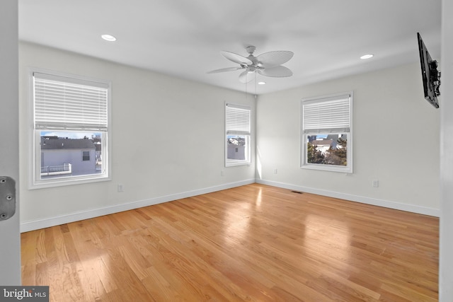 empty room featuring light wood-style floors, recessed lighting, and baseboards