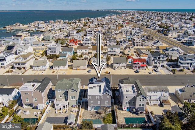 bird's eye view with a water view and a residential view