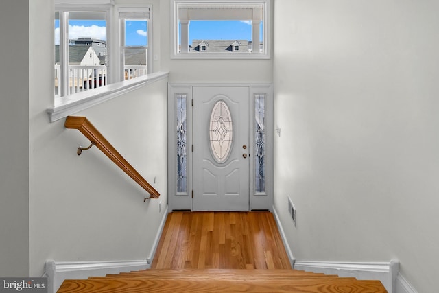 entrance foyer featuring wood finished floors, visible vents, and baseboards