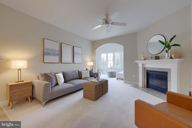 carpeted living room with ceiling fan