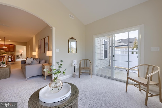 sitting room featuring lofted ceiling and light colored carpet