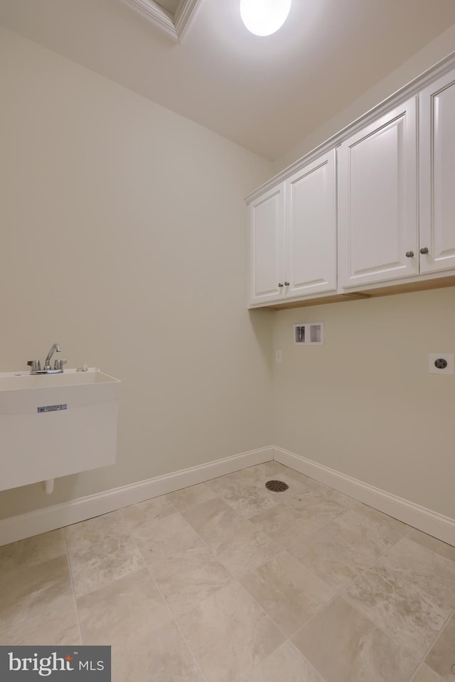 laundry area featuring sink, hookup for a washing machine, cabinets, and hookup for an electric dryer