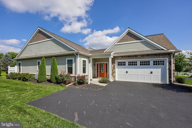 view of front facade with a garage and a front yard