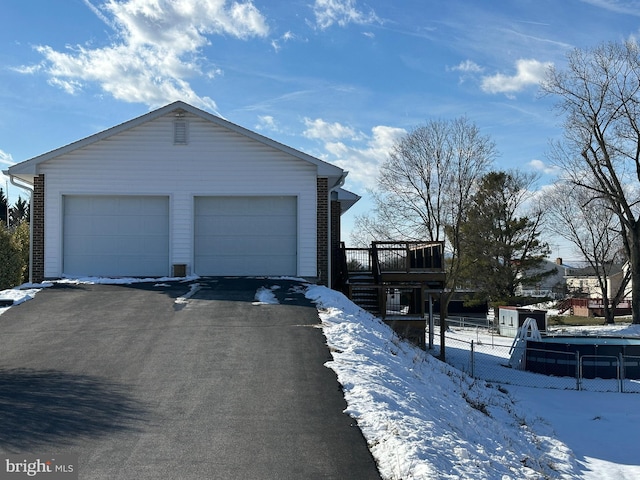 exterior space with a garage and a wooden deck