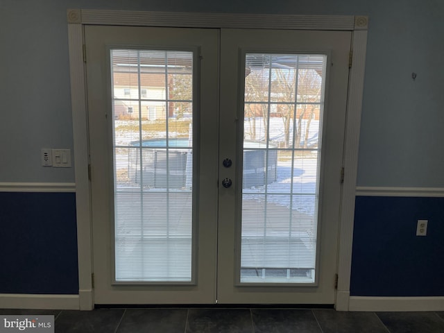 doorway featuring french doors and dark tile patterned floors