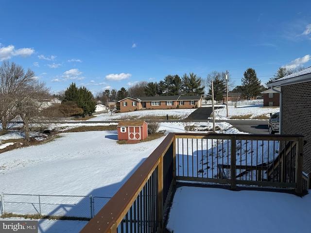 snow covered deck with a storage unit