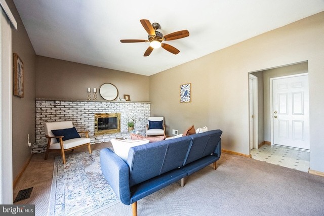 living room with visible vents, a brick fireplace, baseboards, carpet, and a ceiling fan