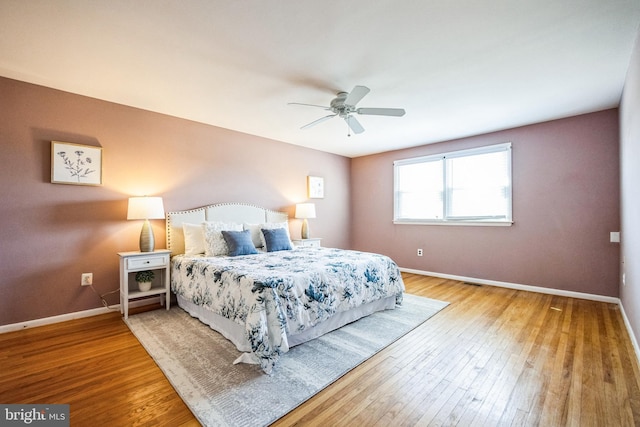 bedroom with hardwood / wood-style flooring, baseboards, and ceiling fan