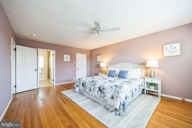 bedroom with a ceiling fan, visible vents, baseboards, and wood-type flooring