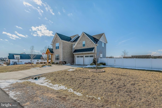 view of front of property featuring a garage and a front lawn