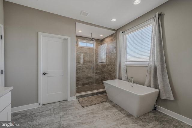 bathroom featuring independent shower and bath