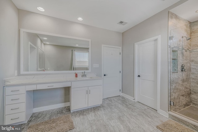 bathroom featuring vanity and an enclosed shower