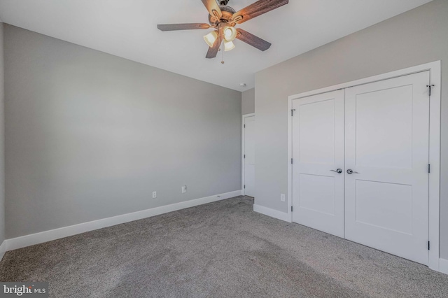 unfurnished bedroom with carpet flooring, ceiling fan, and a closet