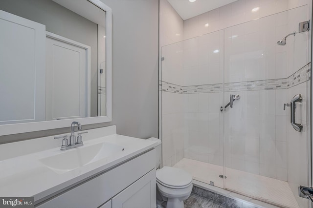 bathroom featuring walk in shower, vanity, and toilet