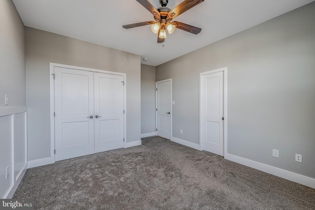 unfurnished bedroom featuring a closet, ceiling fan, and carpet