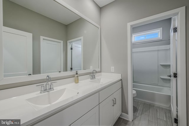 full bathroom featuring vanity, shower / bathtub combination, and toilet