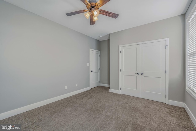 unfurnished bedroom with carpet flooring, ceiling fan, and a closet