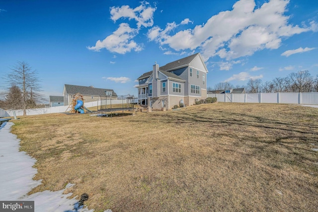 view of yard featuring a playground and a trampoline