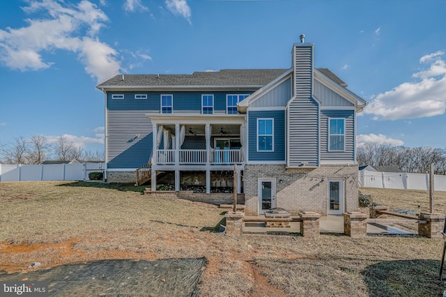 back of house featuring ceiling fan, a yard, and a patio area