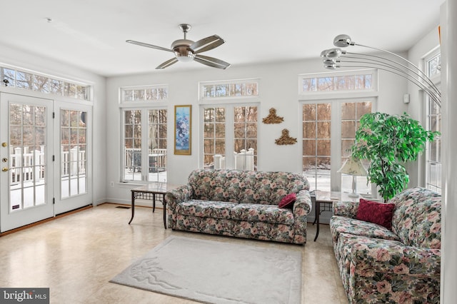 sunroom / solarium featuring ceiling fan