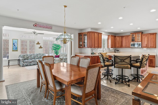 tiled dining room featuring ceiling fan