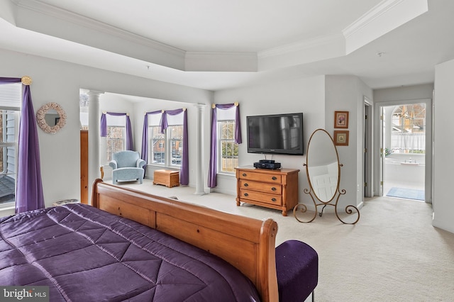 bedroom with multiple windows, ornamental molding, a raised ceiling, and carpet