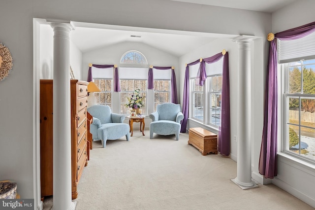 sitting room with lofted ceiling, decorative columns, and carpet flooring