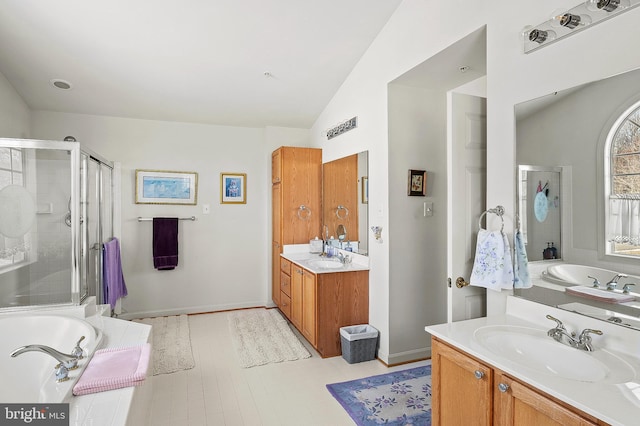 bathroom with vanity, vaulted ceiling, and plus walk in shower