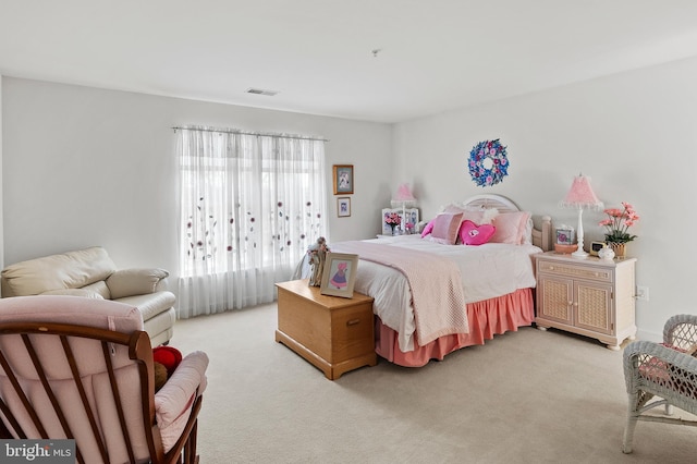 bedroom featuring light carpet