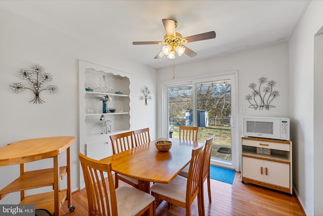 dining area featuring light hardwood / wood-style flooring and ceiling fan