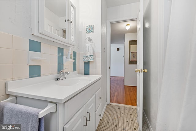 bathroom featuring vanity, tile patterned floors, and tile walls