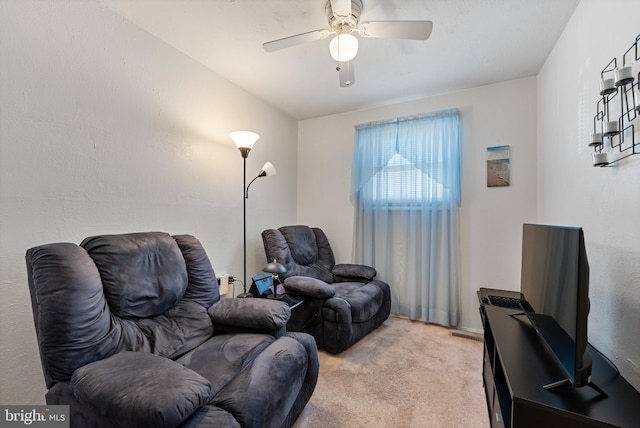 sitting room with light colored carpet and ceiling fan