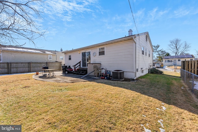 rear view of house featuring a patio, cooling unit, and a lawn