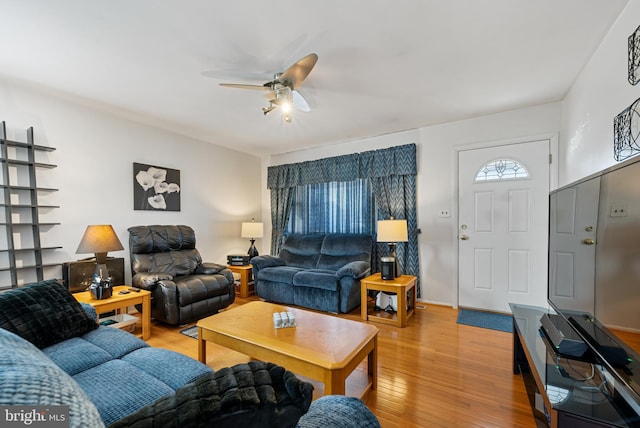 living room featuring ceiling fan and light wood-type flooring