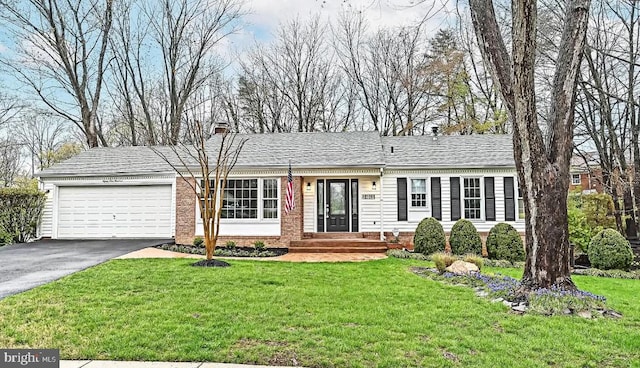 single story home featuring a garage and a front lawn