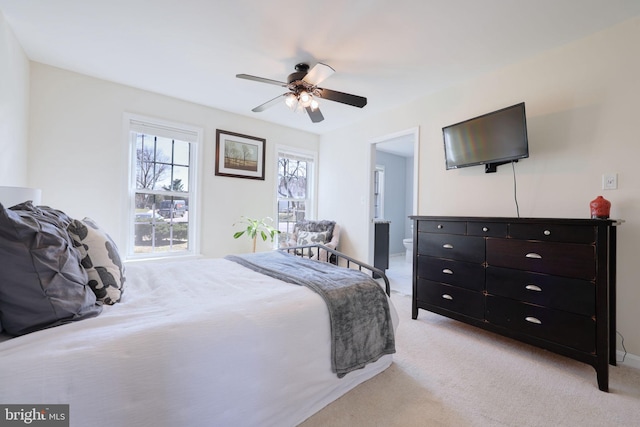 bedroom featuring light colored carpet and a ceiling fan