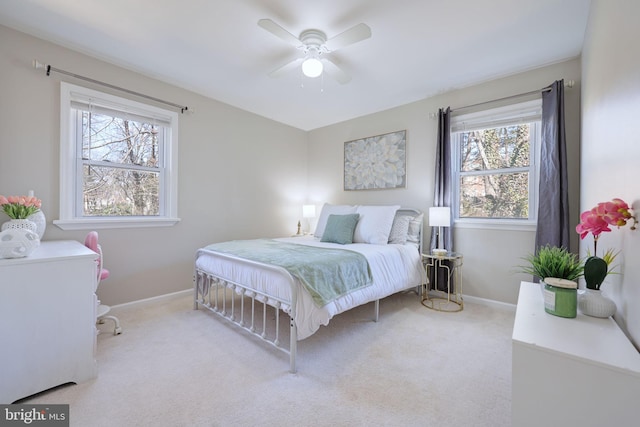 carpeted bedroom featuring ceiling fan and baseboards