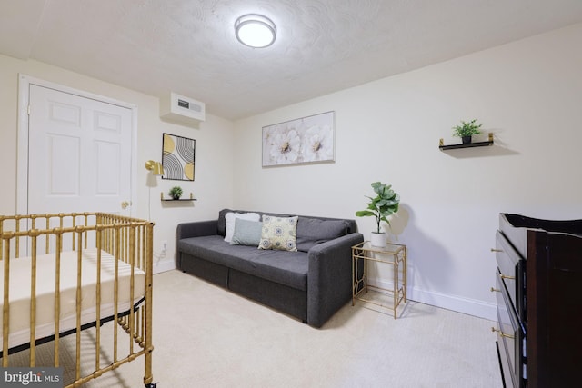 carpeted bedroom with visible vents, a textured ceiling, and baseboards