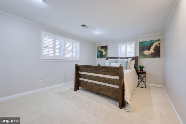 bedroom featuring visible vents, baseboards, ornamental molding, and carpet flooring