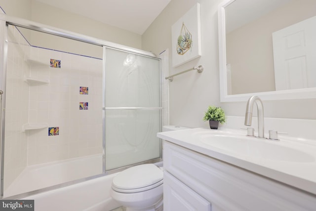 full bathroom with bath / shower combo with glass door, toilet, and vanity