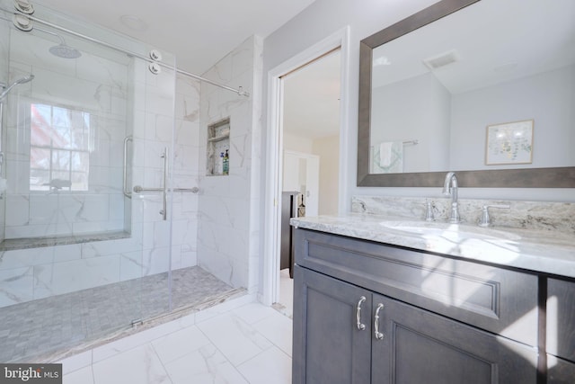 bathroom with vanity, visible vents, marble finish floor, and a marble finish shower