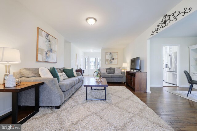 living area with baseboards and wood-type flooring